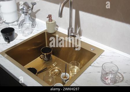 Dirty dishes in kitchen sink Stock Photo