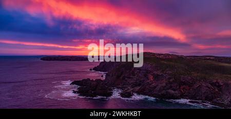 A scenic view of sunset over the sea and coastline Stock Photo