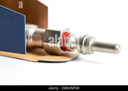 New modern ceramic glow plugs in packaging on a white background. Concept for replacing glow plugs in cold weather. Automotive part Stock Photo