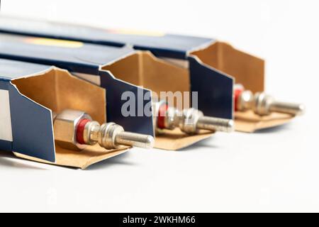 New modern ceramic glow plugs in packaging on a white background. Concept for replacing glow plugs in cold weather. Automotive part Stock Photo