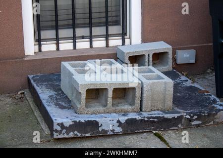 A pile of cinder blocks in front of a structure Stock Photo