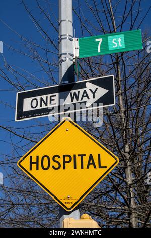 The street signs hanging from a pole on a roadside Stock Photo