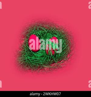 Easter eggs in a nest of grass on a pink background. Stock Photo