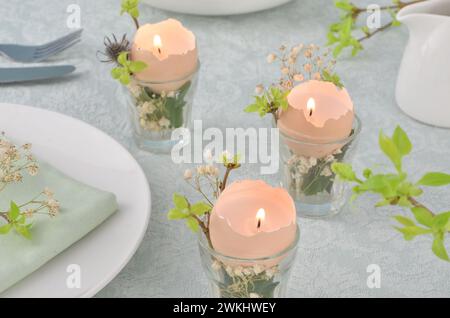 Easter, spring, hand made decoration on a table. Handmade candles from egg shells. Stock Photo