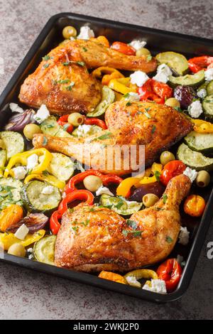 Greek Sheet Pan Chicken With Vegetables and Feta closeup on the table. Vertical Stock Photo