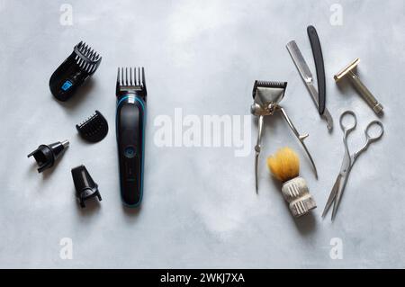Old and new hair clipper and shaving supplies on white rustic background, barber accessories Stock Photo
