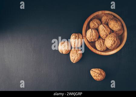 Inshell walnuts in a plate. Heart Nuts, Heart Health Products, Structured Walnuts . Healthy food protein. Fresh raw walnuts full of healthy fats, fibe Stock Photo