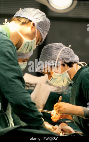 Doctors perform a Cesarean section of an operating room in a maternity ...