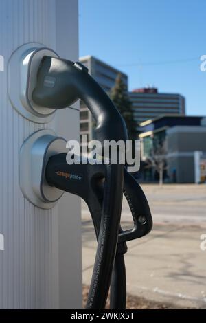 Plugs on a ChargePoint electric vehicle public charge station EV charger, in Flint Michigan USA Stock Photo