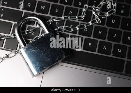 Cyber security. Padlock with chain on laptop, top view Stock Photo