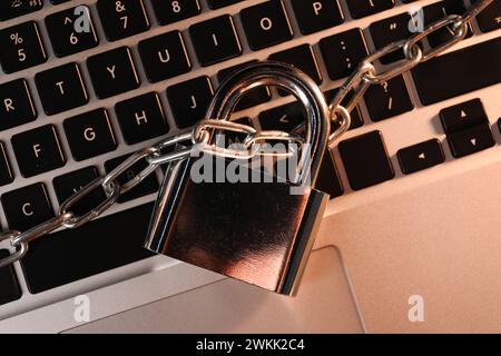 Cyber security. Padlock with chain on laptop, top view Stock Photo