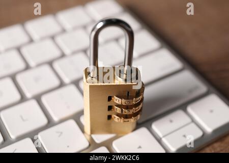 Cyber security. Keyboard with padlock on table, closeup Stock Photo