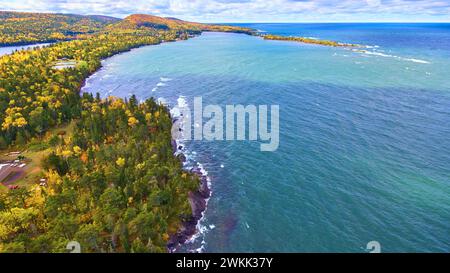 Aerial view of the vibrant coastline where lush green forests meet the ...