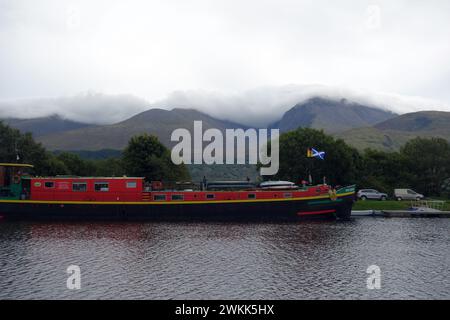 Pleasure Boat 'Ros Crana' a Converted Old Dutch Barge on the Caledonian Canal with Ben Nevis by 'Neptunes Staircase' near Fort William, Scotland, UK. Stock Photo