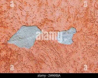 Peeling plaster on a house wall, structural damage Stock Photo