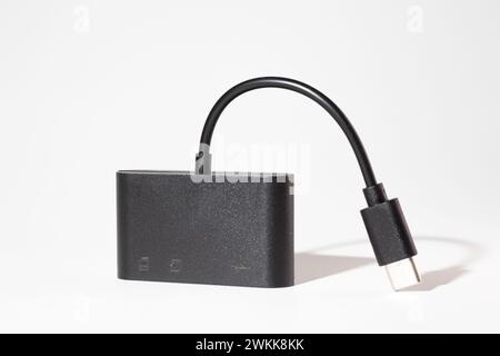 Black USB Type-C 3.1 multi-card reader adapter with short cable for data transfer, isolated on white background. Ideal for tech setups. Stock Photo