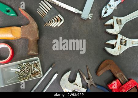 Old tools on concrete floor. Renovation, maintenance and repairing concept. Stock Photo