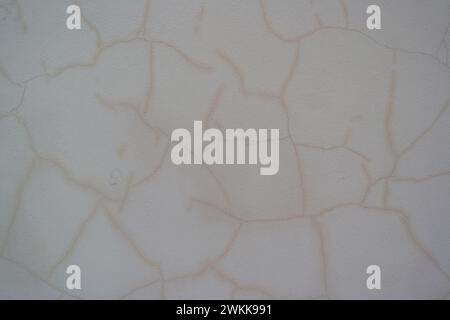 Wall with many cracks in the plaster, structural damage Stock Photo