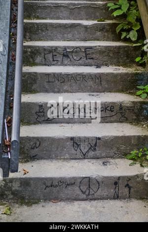 Graffiti-Adorned Urban Stairs with Social Messages, Ascending View Stock Photo