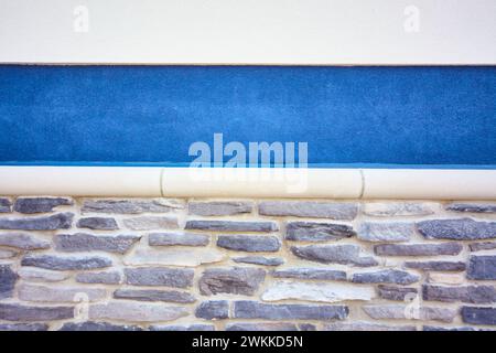 Textured Architectural Detail with Blue Accent Strip Stock Photo