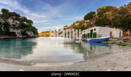 Cala Pi, Spain - 28 January, 2024: idyllic cove and beach at Cala Pi with the boathouse in warm morning light Stock Photo
