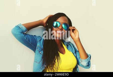 Portrait of stylish young african woman with dreadlocks posing wearing casual in the city Stock Photo