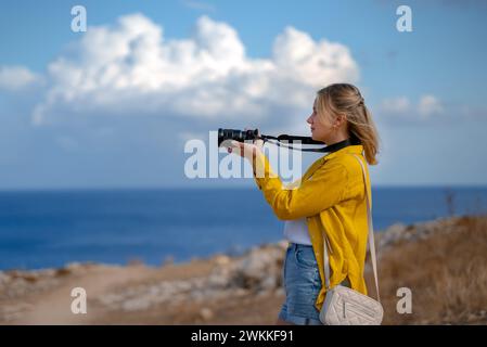 A woman photographer takes pictures of wildlife nature. Stock Photo