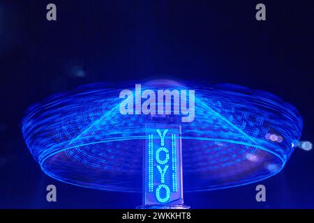 Infrared Swinging Chair-O-Planes Ride at Night with Light Trails at Fair Stock Photo