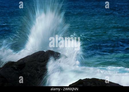 Wave crashing on rocks Stock Photo