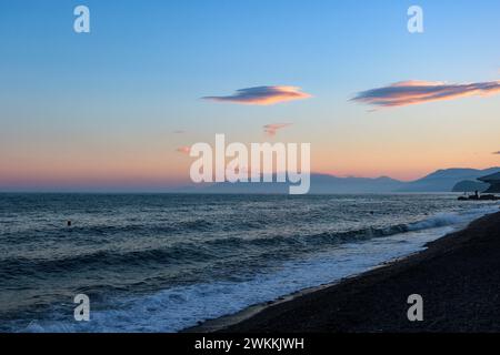 Evening seascape at sunset, sky with Altocumulus lenticularis clouds. Stock Photo