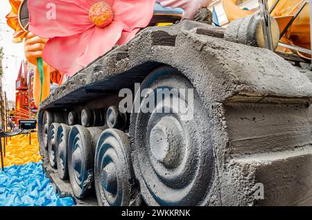 Carnival Float of a Military Tank with Pink Flowers on it. Annual Carnaval Parade Protests Against War and Weapons in Patra City, Greece, Europe. Stock Photo