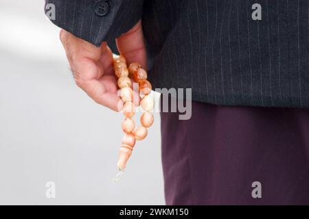 Muslim holding a prayer chain Stock Photo