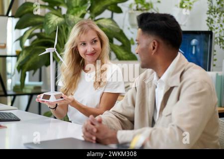 Team of industrial engineers discussing new model of wind turbine Stock Photo