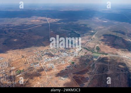 aerial cityscape with town near river in desert,  shot from a glider plane in bright late spring light from east at Gobabis, Namibia, Africa Stock Photo