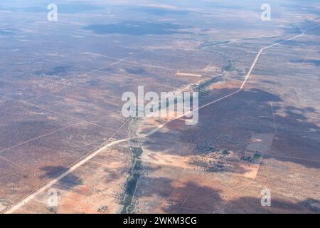 aerial landscape with C30 road and Black Nossob river in desert,  shot from a glider plane in bright late spring light north Gobabis, Namibia, Africa Stock Photo
