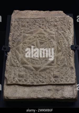 Plaque or brick decorated in relief with religious motif. Chrismon with geometric decoration. Baked clay. 4th-5th centuries. Provenance unknown. Museum of Visigoth Councils and Culture. Toledo, Castile-La Mancha, Spain. Stock Photo