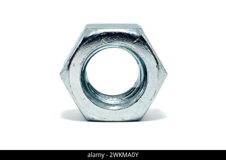 Close up of a single silver coloured hex nut isolated against a white background. Stock Photo