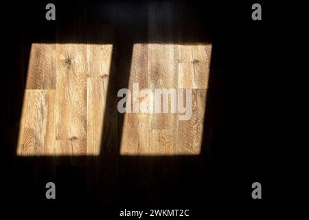 A shadow from the window. Sunlight from the window falls on the wooden floor. Stock Photo