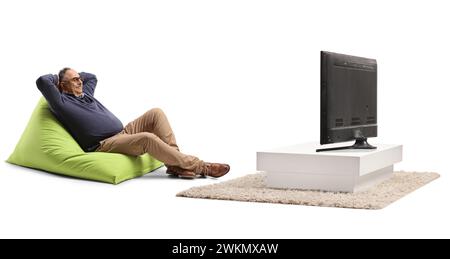 Mature man sitting on a green beanbag chair and relaxing in front of tv isolated on white background Stock Photo