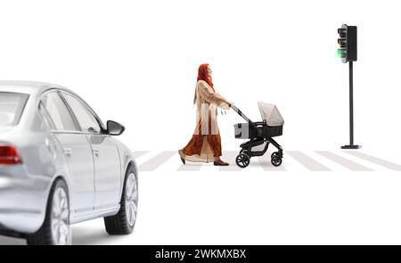 Full length profile shot of a mother in a hijab pushing a baby stroller at a pedestrian crossing isolated on white background Stock Photo