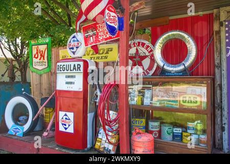 Vintage Skelly memorabilia and other automotive antique objects on display in a yard on a summer day in St. Cloud, Minnesota USA Stock Photo