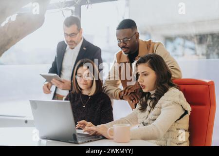 Coworkers collaborating on business expansion, analyzing market research, and maximizing profitability. Innovative teamwork driving start-up success. Stock Photo