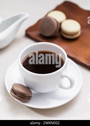 Cup of coffee and macaroons on the table on a light background Stock Photo