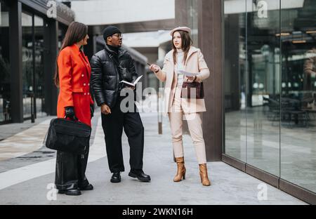 Diverse business professionals engaging in casual discussion outdoors Stock Photo