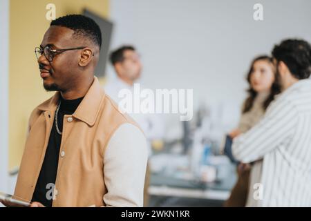 Diverse coworkers collaborating, analyzing statistics, and strategizing for market analysis in a creative office. Stock Photo