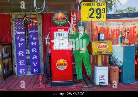 Vintage Skelly memorabilia and other automotive antique objects on display in a yard on a summer day in St. Cloud, Minnesota USA. Stock Photo