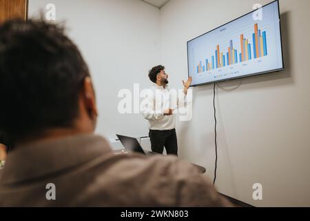 Successful multicultural team analyzing statistics in a boardroom meeting. Stock Photo