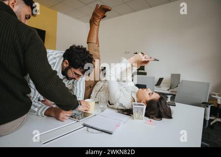 Multiracial team collaborating on business project in office workspace. Stock Photo