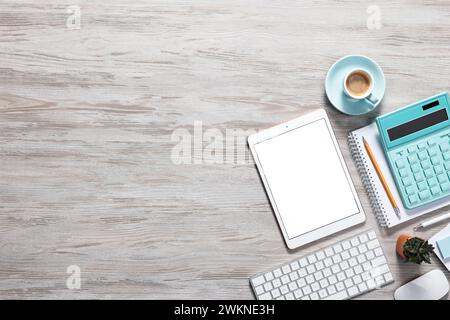Flat lay composition with modern tablet on white wooden table. Space for text Stock Photo