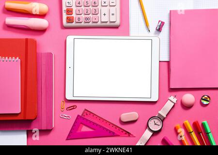 Modern tablet, calculator and stationery on pink background, flat lay. Space for text Stock Photo